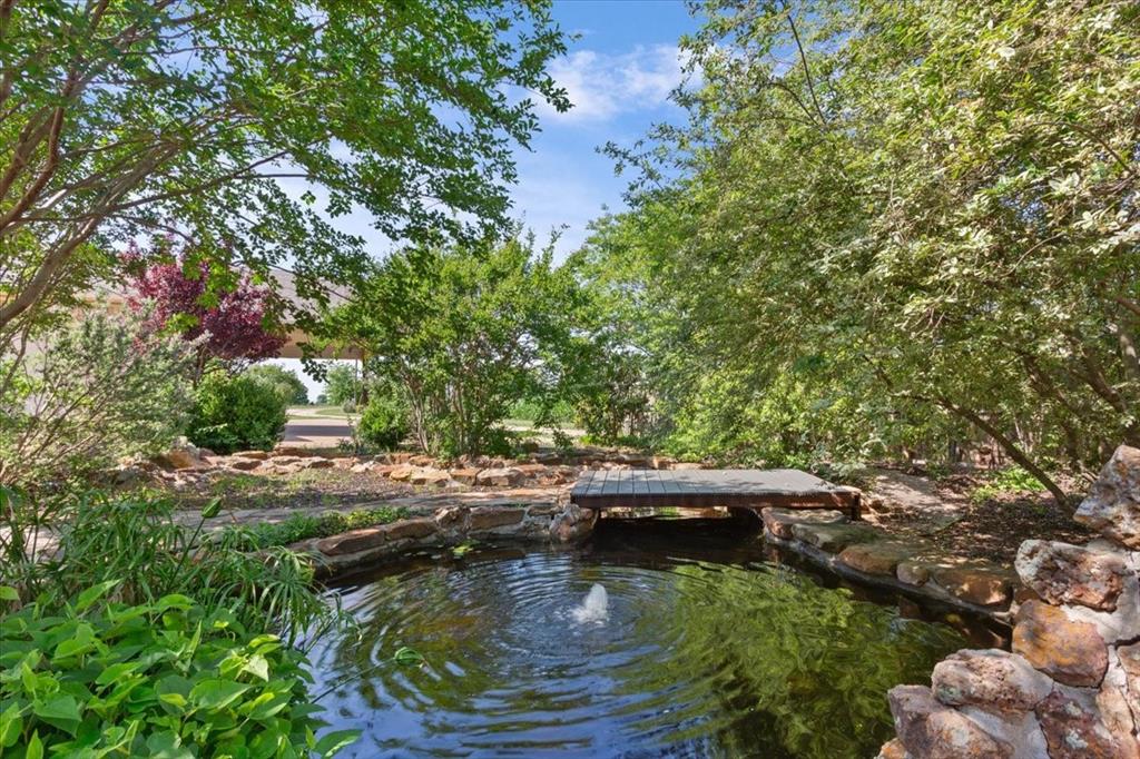 3439 Willow Branch Road McGregor, TX 76657 - Photo 30 of 40 a view of a lake with lawn chairs and a fire pit
