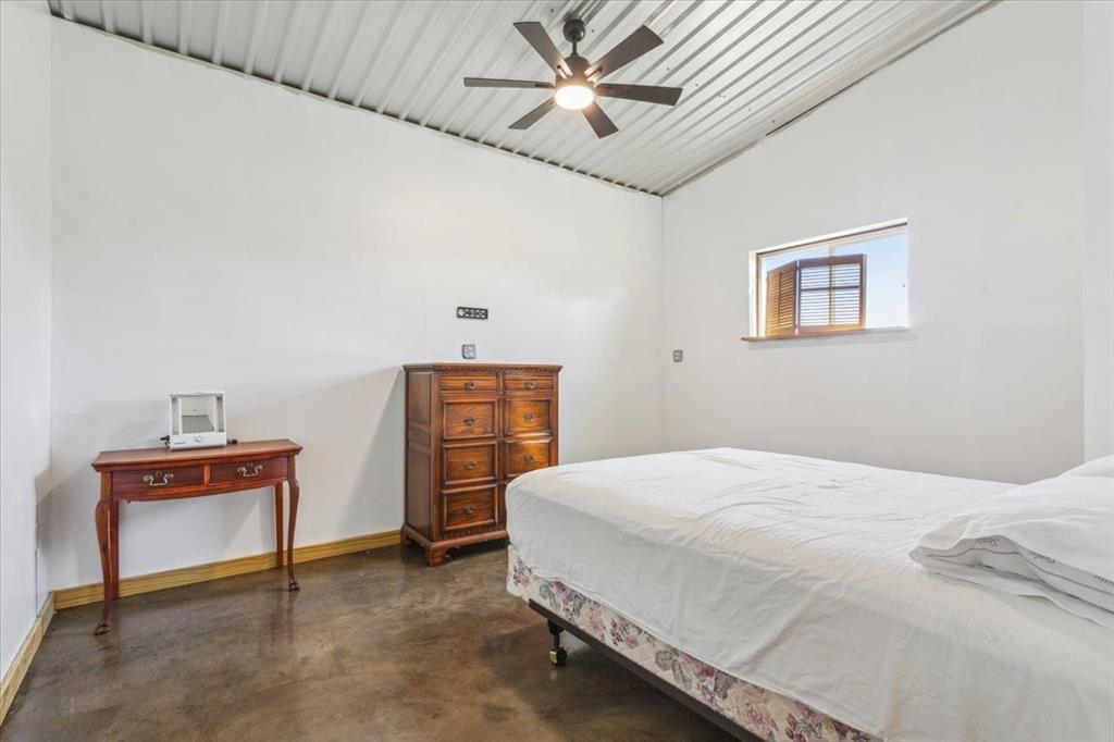 3439 Willow Branch Road McGregor, TX 76657 - Photo 37 of 40 a bedroom with a bed and a desk