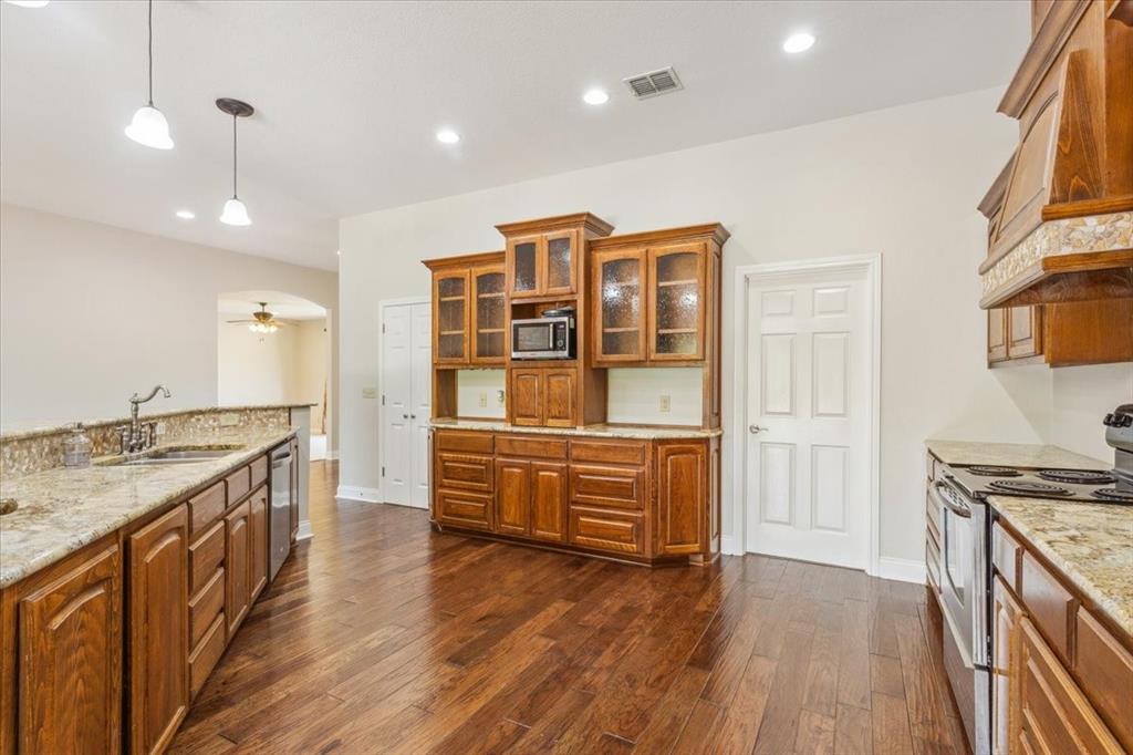 3439 Willow Branch Road McGregor, TX 76657 - Photo 10 of 40 a kitchen with stainless steel appliances granite countertop a stove and a sink