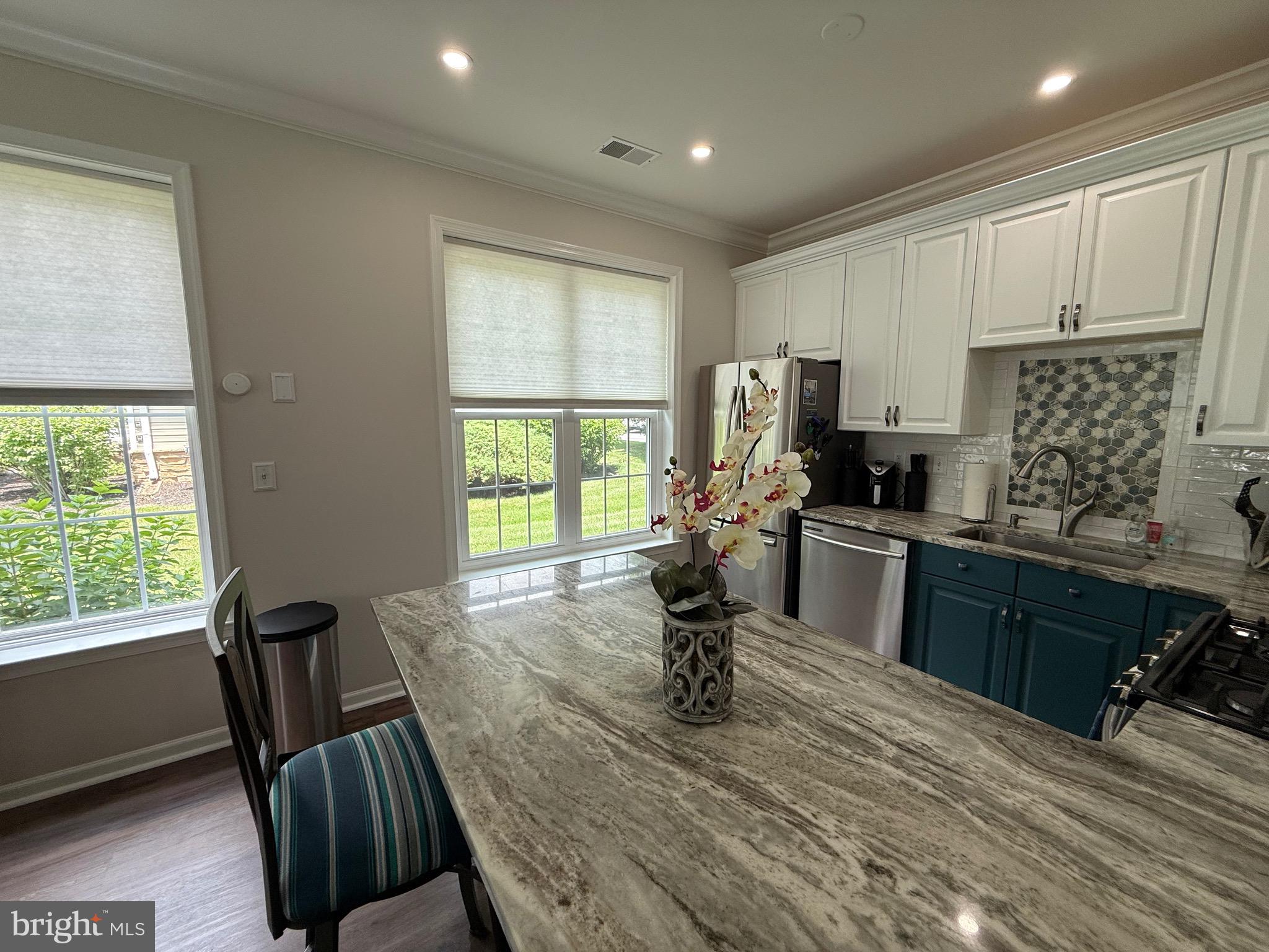 76 Kyle Way Ewing, NJ 08628 - Photo 14 of 38 a kitchen with a table chairs refrigerator and microwave