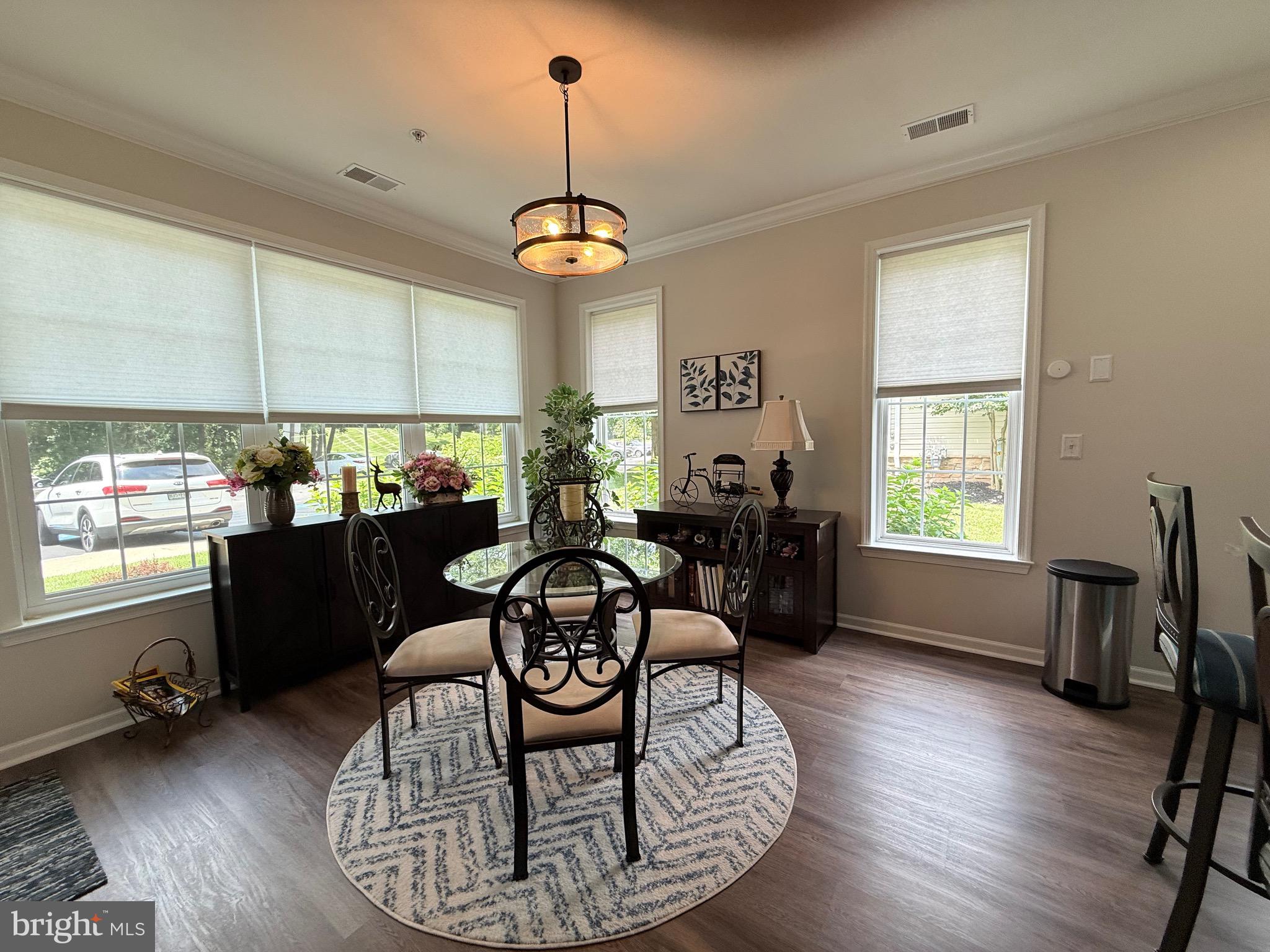 76 Kyle Way Ewing, NJ 08628 - Photo 15 of 38 a view of a dining room and livingroom with furniture wooden floor a chandelier
