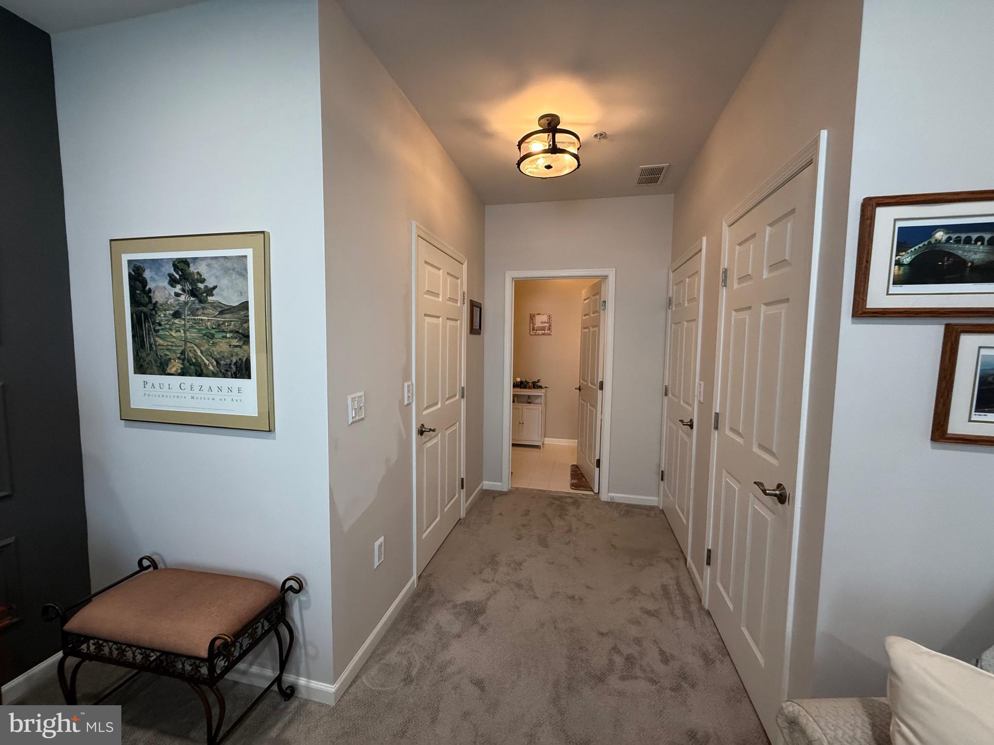 76 Kyle Way Ewing, NJ 08628 - Photo 22 of 38 a view of a hallway with paintings on the wall
