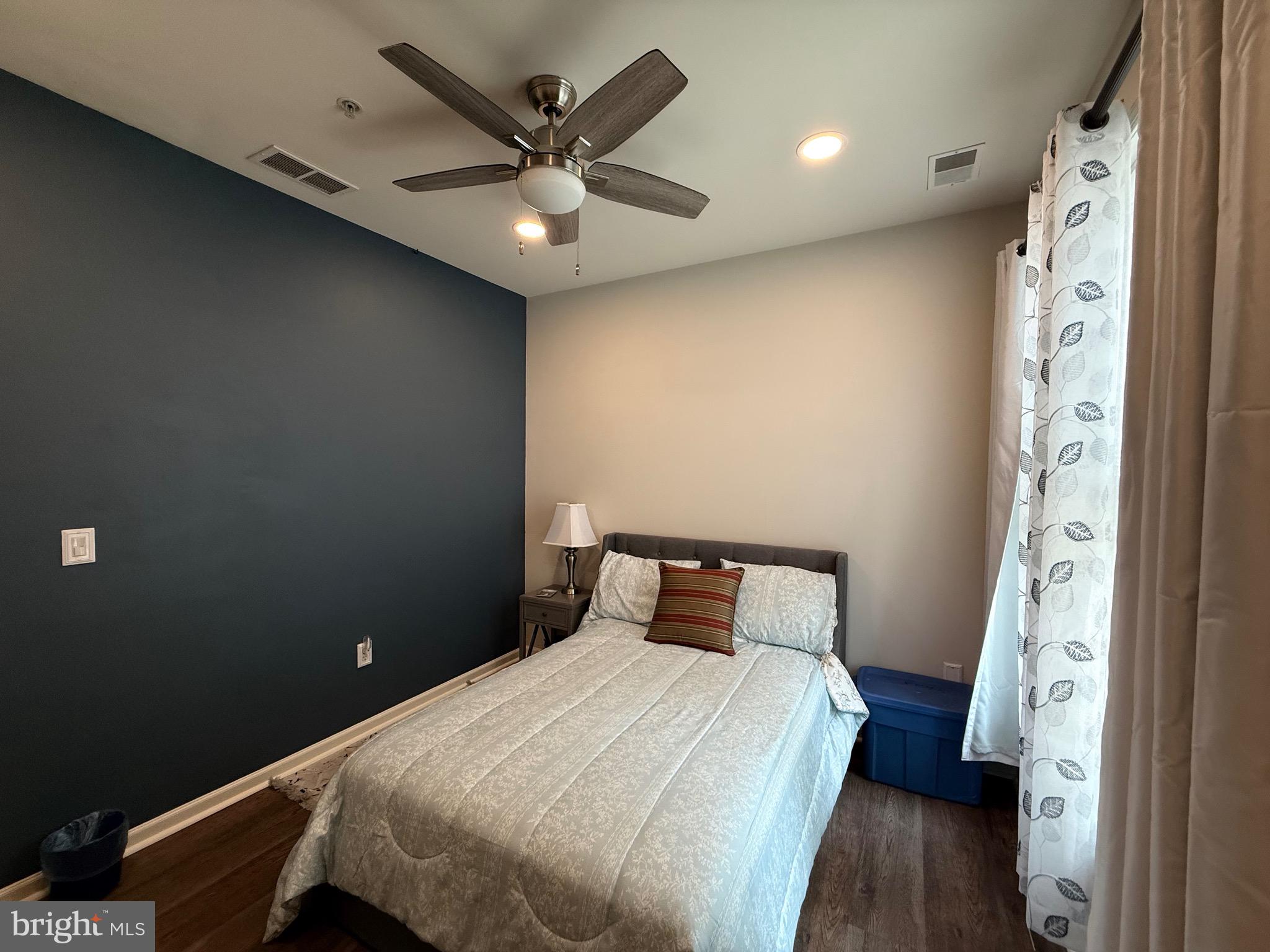 76 Kyle Way Ewing, NJ 08628 - Photo 29 of 38 a bedroom with a bed and a chandelier