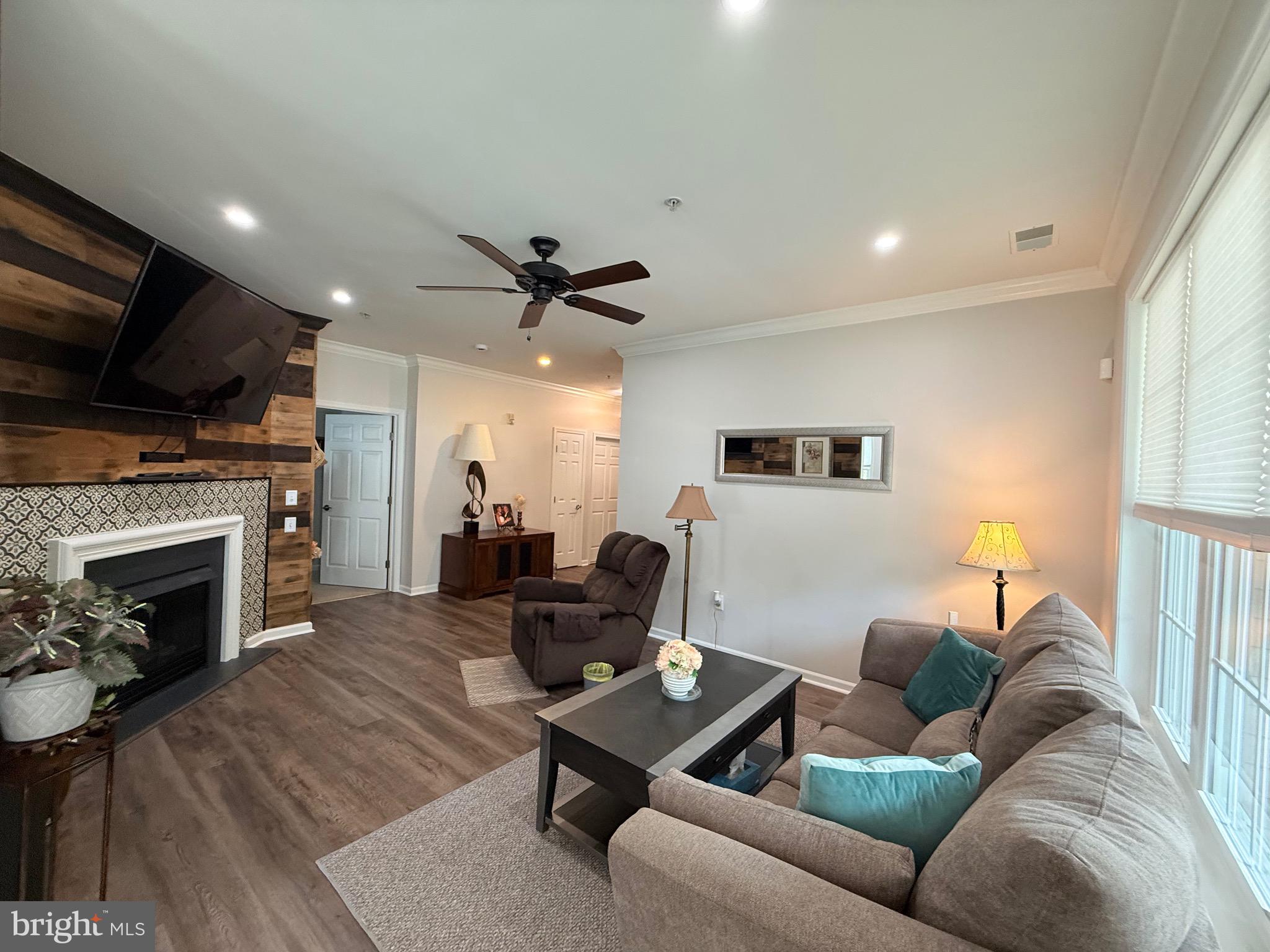 76 Kyle Way Ewing, NJ 08628 - Photo 10 of 38 a living room with furniture a fireplace and a flat screen tv