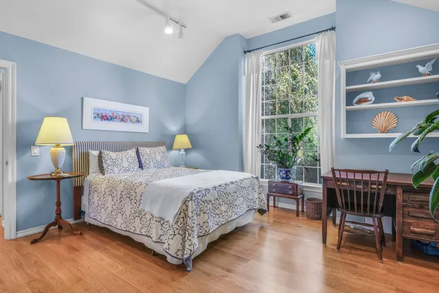 a bedroom with a bed and a large window