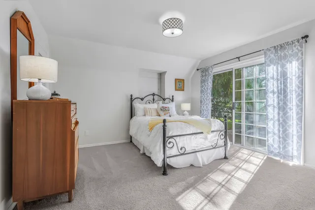 a spacious bedroom with a bed and a window