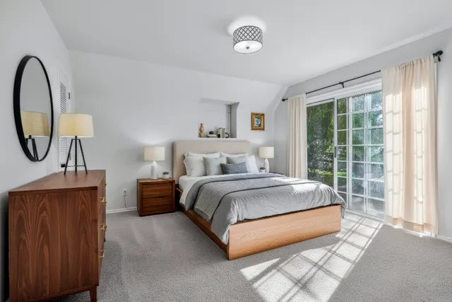 a spacious bedroom with a bed and a window