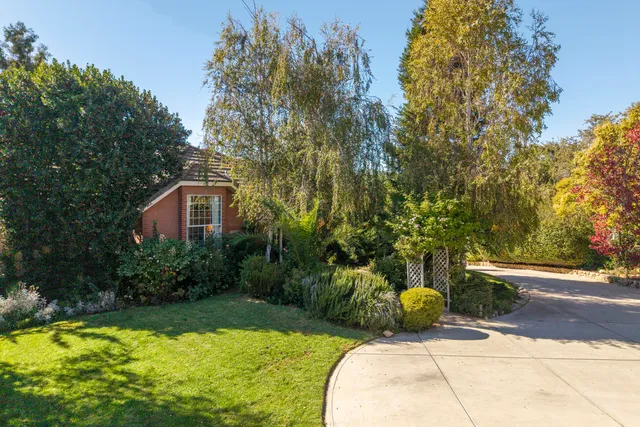 a view of backyard with swimming pool and seating space