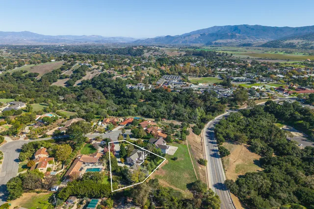 an aerial view of residential house and sandy dunes