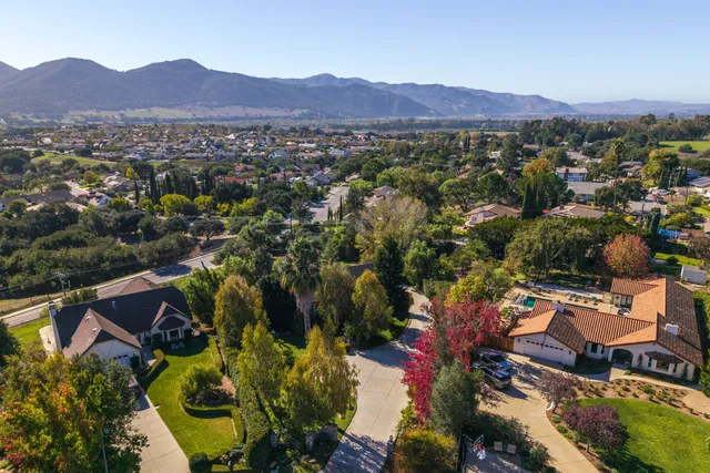 an aerial view of residential house and sandy dunes