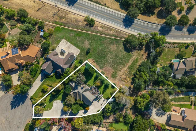 an aerial view of residential house and sandy dunes