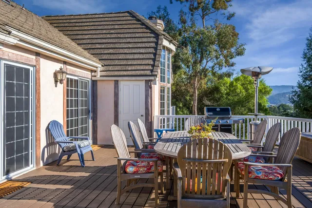 a view of a chairs and table in the balcony
