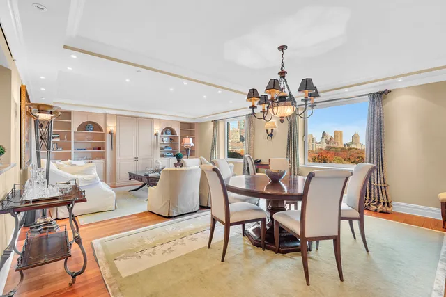 a dining room with furniture a chandelier and wooden floor