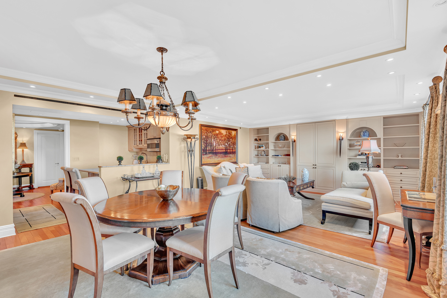 160 Central Park South, Unit 1015/1018 Manhattan, NY 10019 - Photo 3 of 10 a dining room with furniture a chandelier and wooden floor