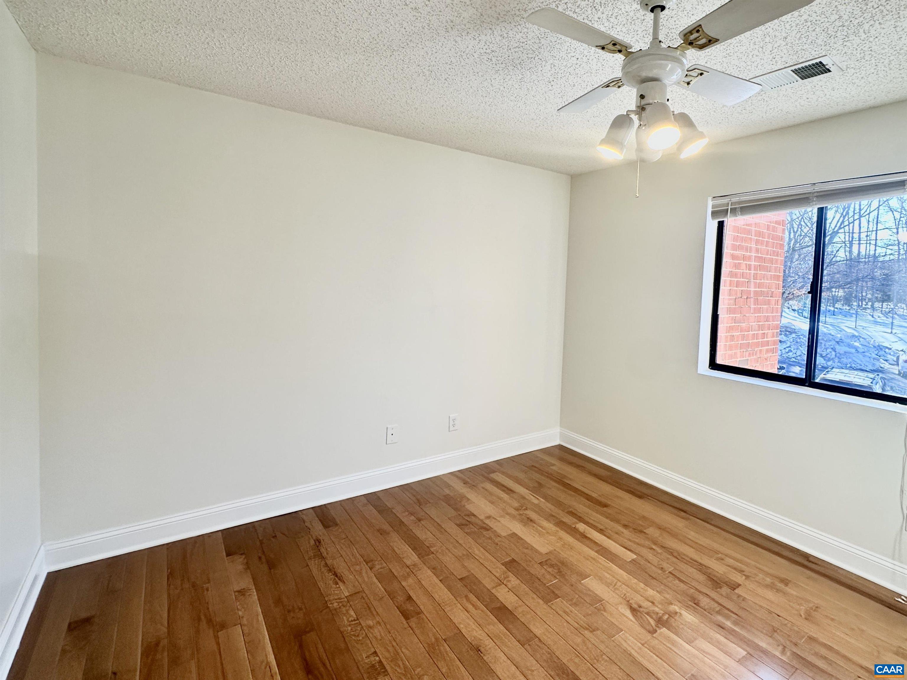 101 Turtle Creek Road, Unit 5 Charlottesville, VA 22901 - Photo 11 of 23 wooden floor in an empty room with a window