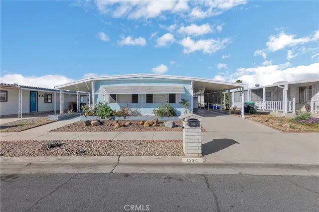 a view of a white house with a fountain in front of it