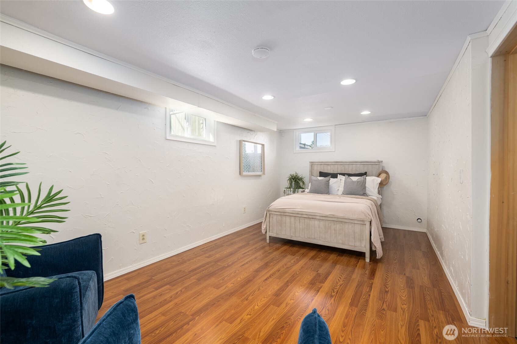 819 K Avenue Anacortes, WA 98221 - Photo 27 of 40 a spacious bedroom with a bed and wooden floor