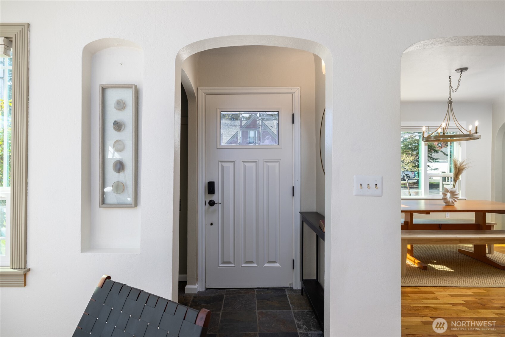 819 K Avenue Anacortes, WA 98221 - Photo 3 of 40 a view of a hallway with wooden floor and a dining room