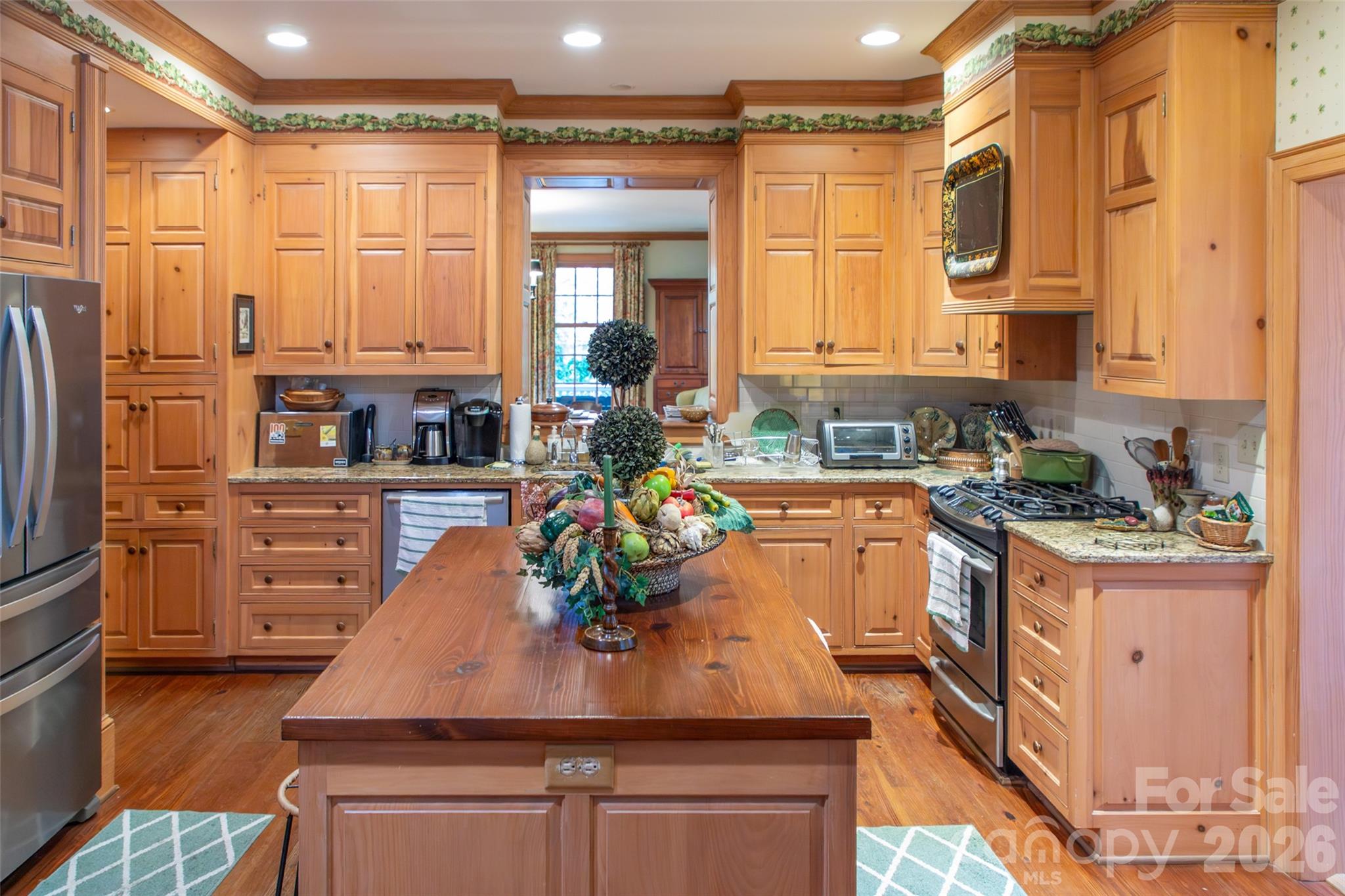 213 Union Street North Concord, NC 28025 - Photo 26 of 43 a kitchen with stainless steel appliances granite countertop a stove a sink and a refrigerator