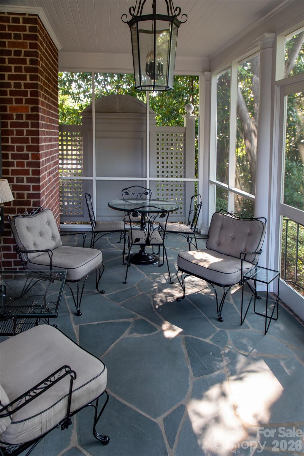 213 Union Street North Concord, NC 28025 - Photo 34 of 43 a living room with patio furniture and a chandelier