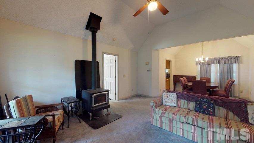 6720 Kiger Road Rougemont, NC 27572 - Photo 11 of 22 a living room with furniture a piano and a flat screen tv