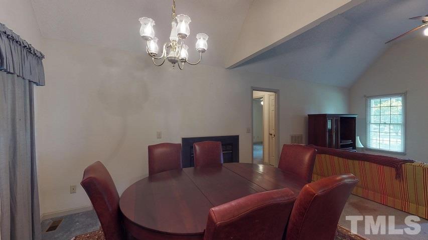 6720 Kiger Road Rougemont, NC 27572 - Photo 14 of 22 a view of a dining room with furniture and chandelier