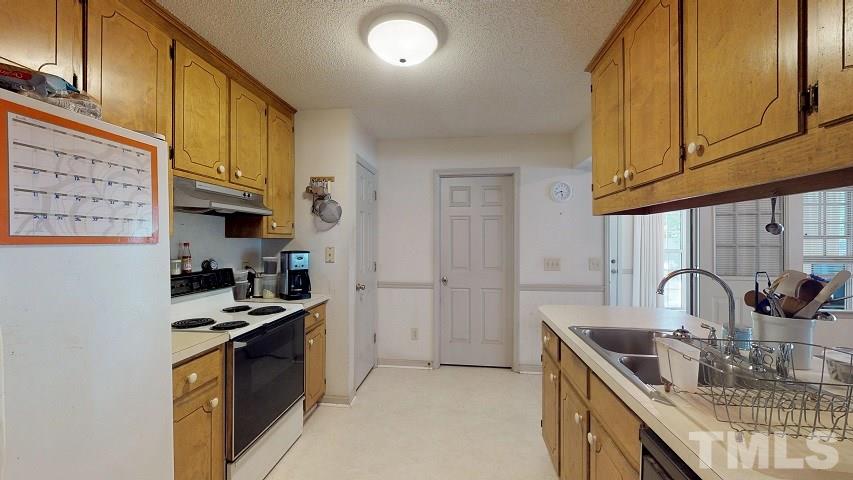 6720 Kiger Road Rougemont, NC 27572 - Photo 16 of 22 a kitchen with stainless steel appliances granite countertop a sink stove and refrigerator