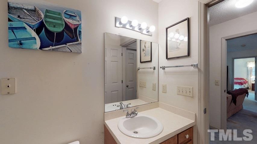 6720 Kiger Road Rougemont, NC 27572 - Photo 22 of 22 a bathroom with a sink a mirror and a shower