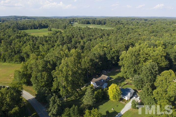 6720 Kiger Road Rougemont, NC 27572 - Photo 4 of 22 a view of a lush green forest with a lake