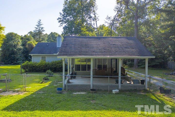 6720 Kiger Road Rougemont, NC 27572 - Photo 7 of 22 a view of a house with a yard and a large tree