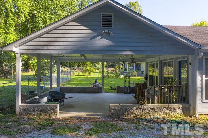 6720 Kiger Road Rougemont, NC 27572 - Photo 9 of 22 a backyard of a house with fountain and outdoor seating