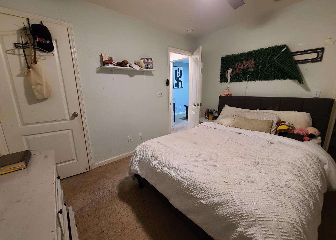 440 East Stanley Avenue Reedley, CA 93654 - Photo 18 of 25 a bedroom with a bed and a walk in closet