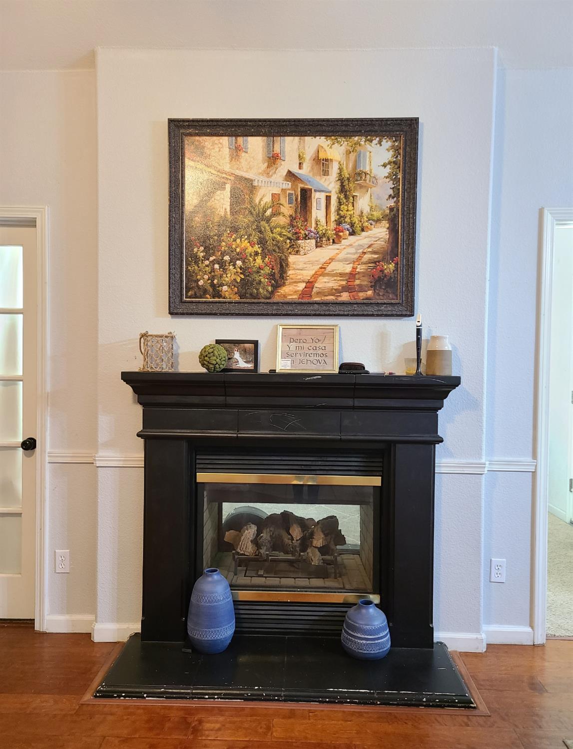 440 East Stanley Avenue Reedley, CA 93654 - Photo 10 of 25 a living room with a fireplace and a wooden floor
