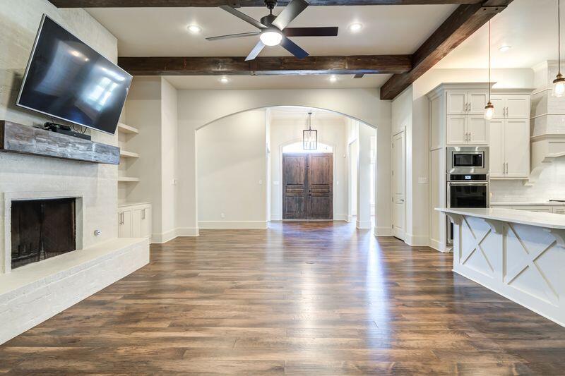 11107 Miami Avenue Lubbock, TX 79423 - Photo 12 of 82 a view of a livingroom with a flat screen tv and fireplace