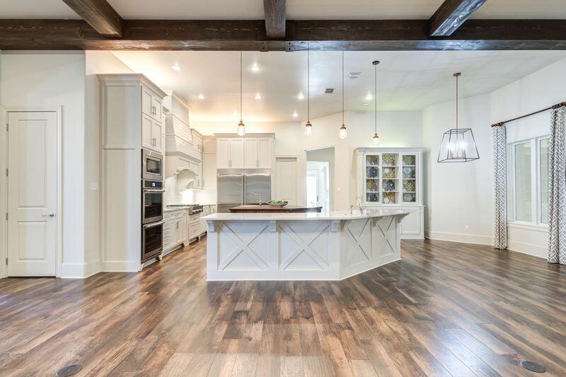 11107 Miami Avenue Lubbock, TX 79423 - Photo 14 of 82 a open kitchen with white cabinets and wooden floor