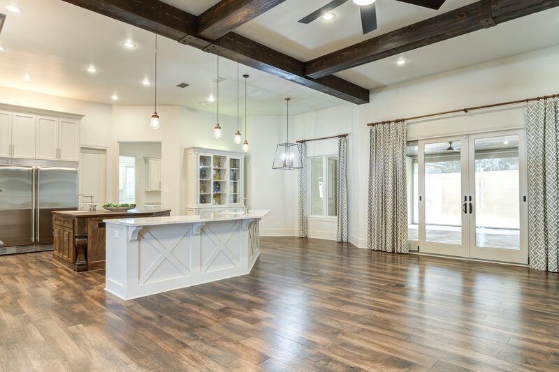 11107 Miami Avenue Lubbock, TX 79423 - Photo 15 of 82 a large kitchen with stainless steel appliances granite countertop a large stove a sink dishwasher and a refrigerator with wooden floor