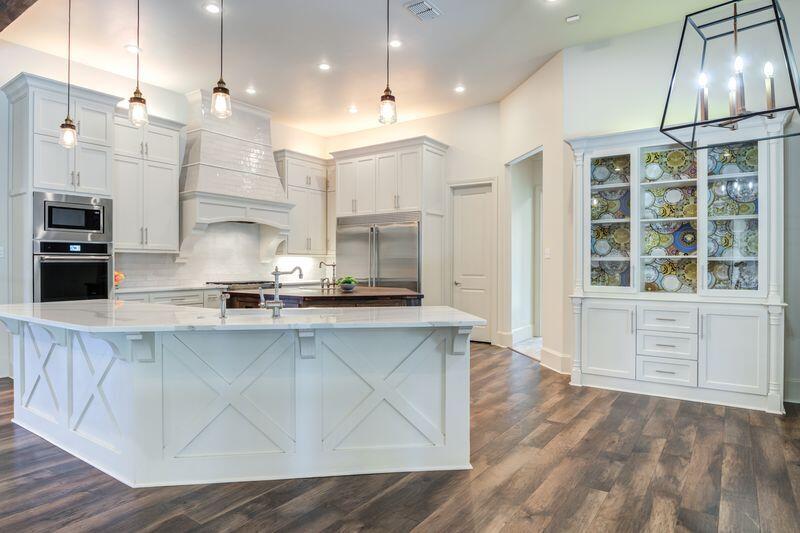 11107 Miami Avenue Lubbock, TX 79423 - Photo 16 of 82 a open kitchen with kitchen island white cabinets and stainless steel appliances