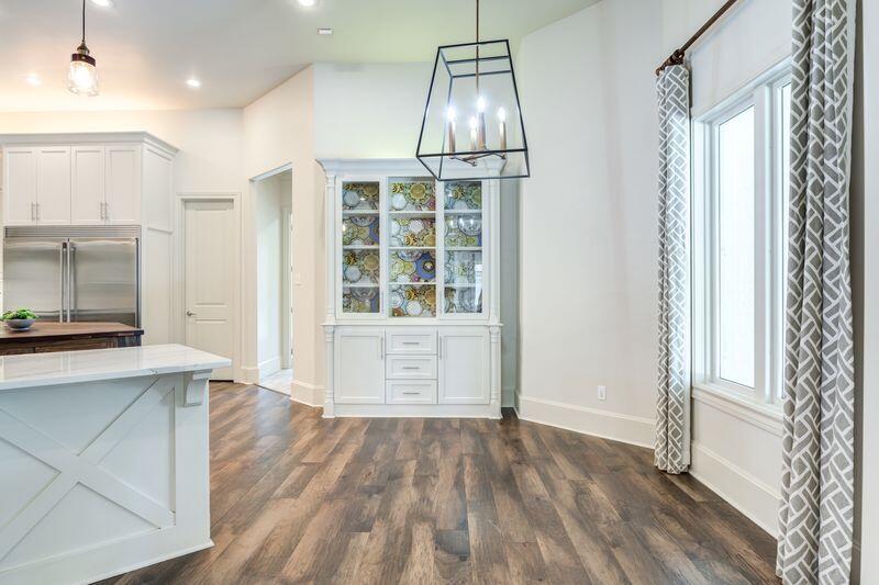 11107 Miami Avenue Lubbock, TX 79423 - Photo 18 of 82 a view of an empty room with a window and wooden floor