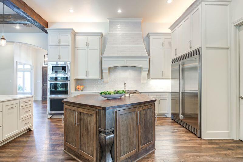 11107 Miami Avenue Lubbock, TX 79423 - Photo 20 of 82 a kitchen with stainless steel appliances granite countertop a kitchen island a stove a refrigerator and a cabinets