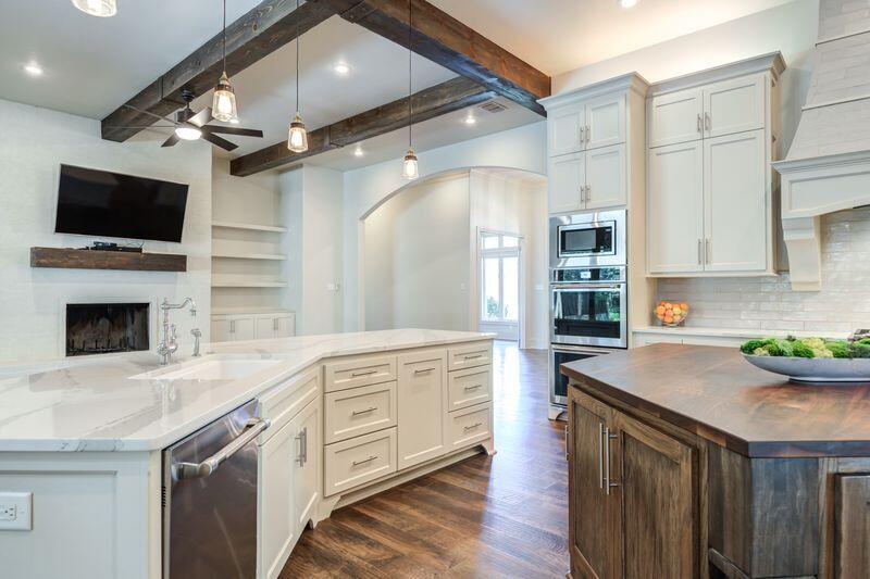 11107 Miami Avenue Lubbock, TX 79423 - Photo 21 of 82 a kitchen with a sink and a stove top oven with wooden floor