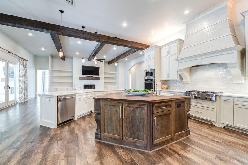 11107 Miami Avenue Lubbock, TX 79423 - Photo 22 of 82 a large kitchen with stainless steel appliances granite countertop a stove and a sink
