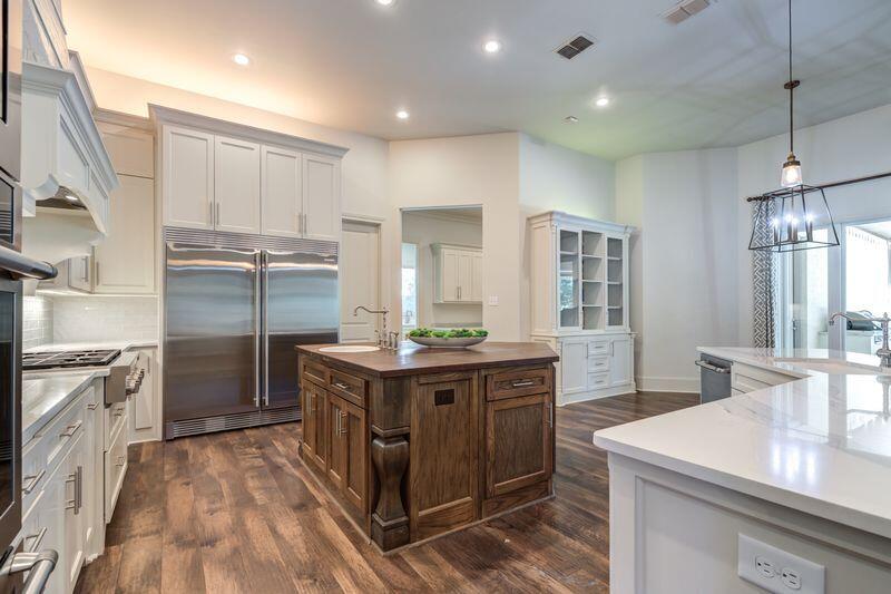 11107 Miami Avenue Lubbock, TX 79423 - Photo 28 of 82 a kitchen with kitchen island granite countertop a sink stove and refrigerator
