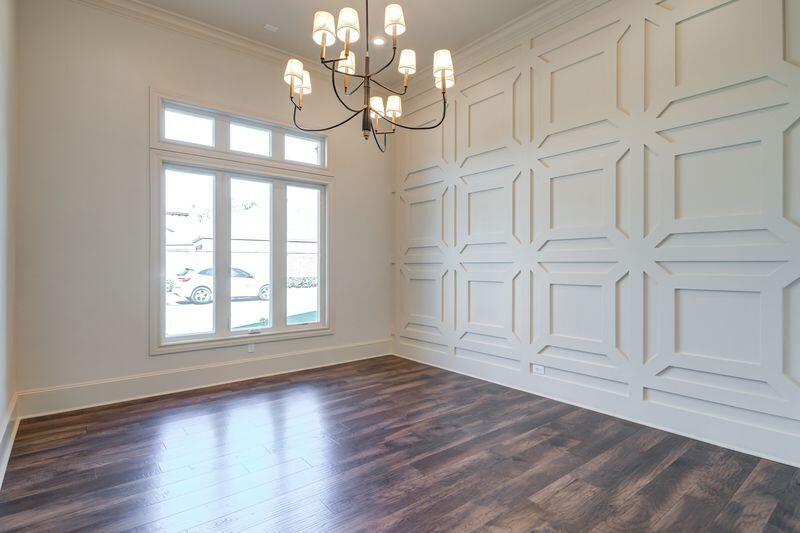 11107 Miami Avenue Lubbock, TX 79423 - Photo 3 of 82 an empty room with wooden floor cabinet and windows