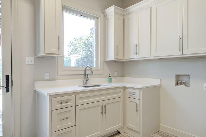 11107 Miami Avenue Lubbock, TX 79423 - Photo 34 of 82 a kitchen with white cabinets and a window