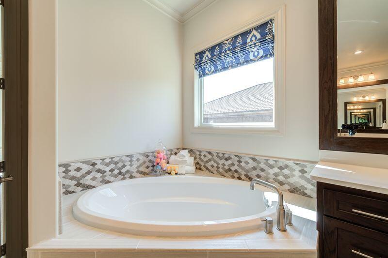 11107 Miami Avenue Lubbock, TX 79423 - Photo 41 of 82 a bath tub sitting in a bathroom next to a window