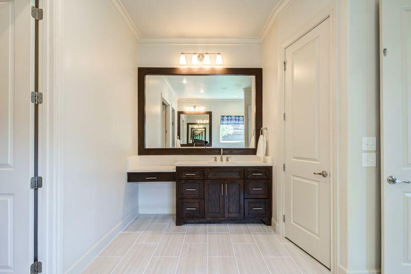 11107 Miami Avenue Lubbock, TX 79423 - Photo 42 of 82 a bathroom with a double vanity sink and a mirror