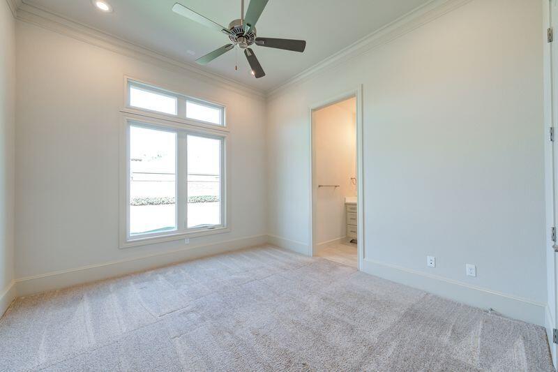 11107 Miami Avenue Lubbock, TX 79423 - Photo 54 of 82 an empty room with chandelier fan and windows