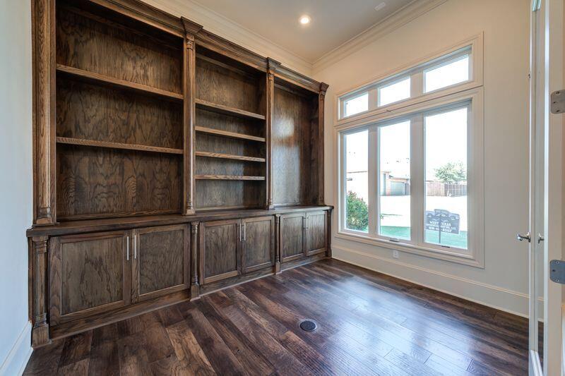 11107 Miami Avenue Lubbock, TX 79423 - Photo 6 of 82 a view of an empty room with a window and wooden floor