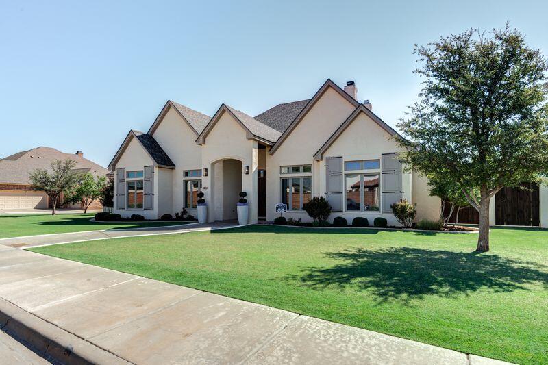 11107 Miami Avenue Lubbock, TX 79423 - Photo 67 of 82 a front view of a house with a garden and trees
