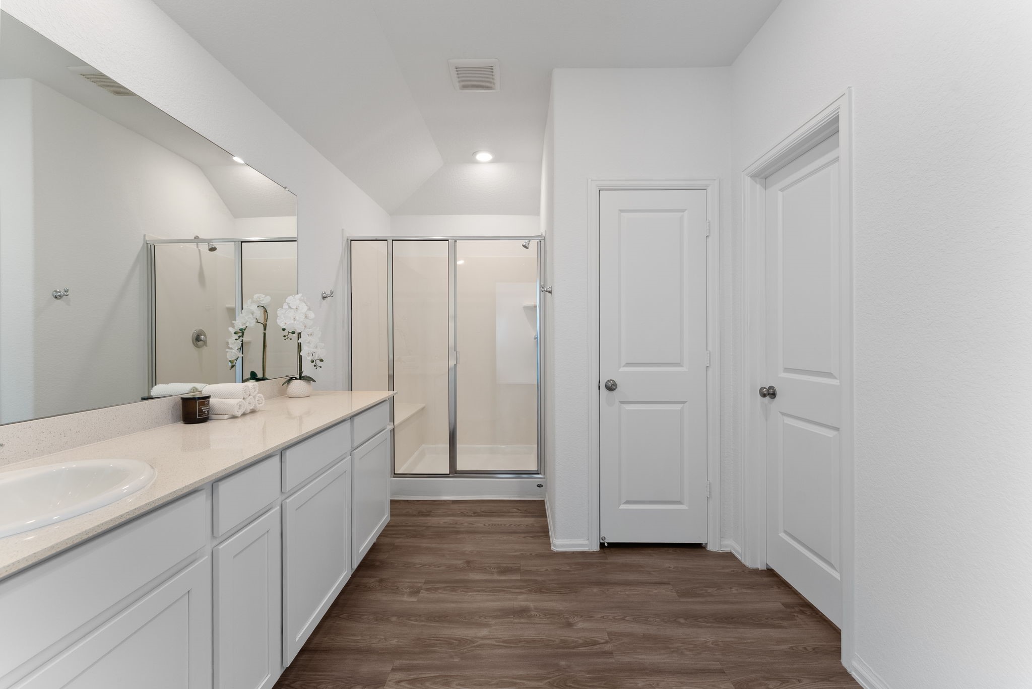 2850 Paradise Ridge Way Conroe, TX 77301 - Photo 12 of 21 Primary vanity with ample storage, a large mirror and a walk-in shower.